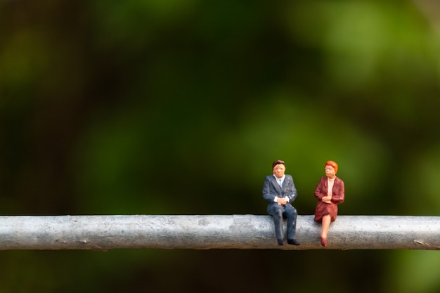business people sitting on a  wire 