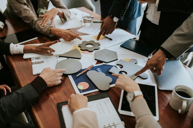 Photo business people solving a puzzle in a meeting