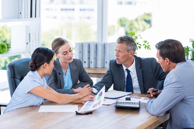 Business people speaking together during meeting 