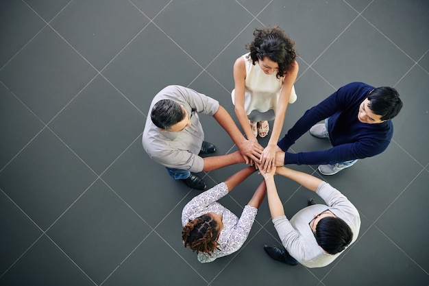 Business people stacking hands