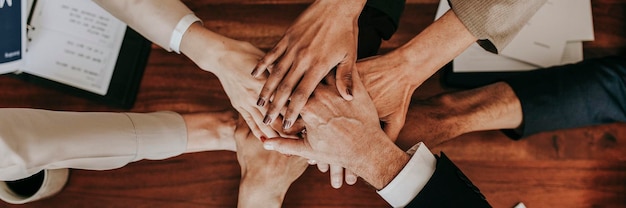 Business people stacking their hands together