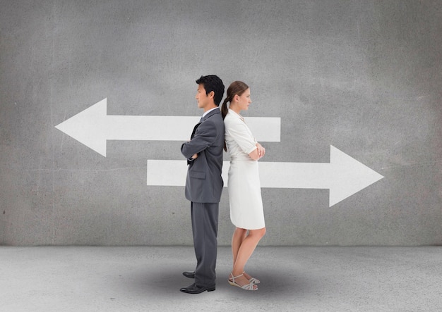 Business people standing against grey background with white arrows