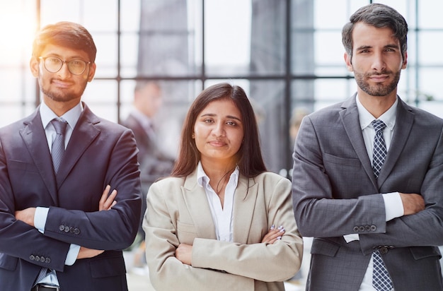 Business people standing and looking straight ahead in a modern office