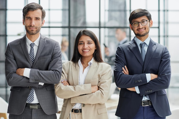 Business people standing and looking straight ahead in a modern office