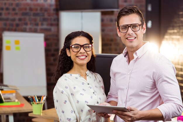 Business people standing with a digital tablet