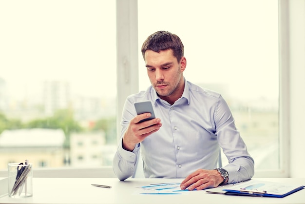 business, people, stress and technology concept - close up of businessman with smartphone