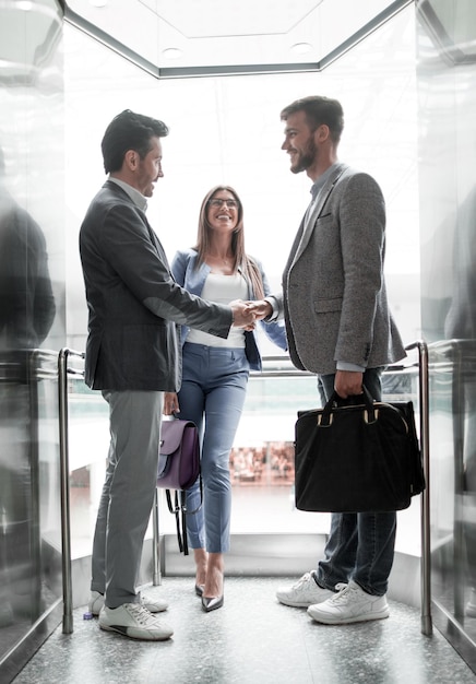 Business people stretching out their hands for a handshake