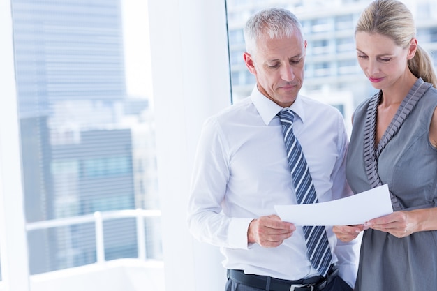 Business people talking over a paper sheet