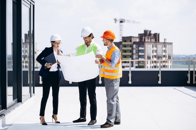 business people talking on the roof of the construction
