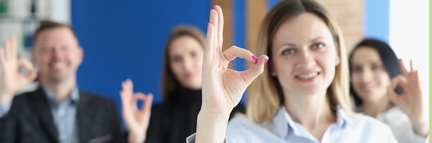 Business people team shows ok gesture in office