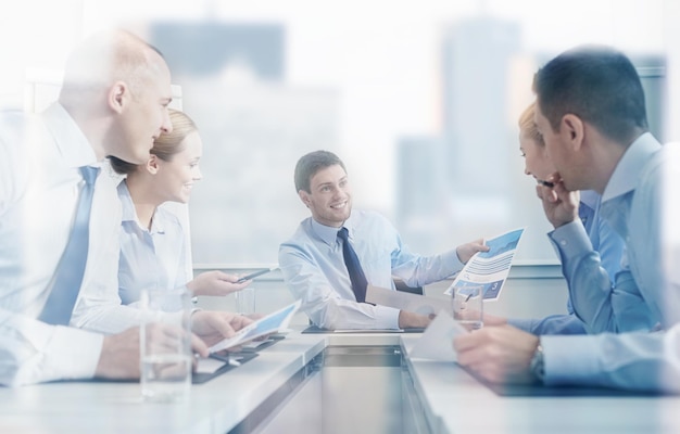 business, people and teamwork concept - group of smiling businesspeople meeting in office