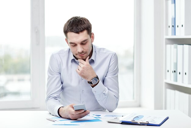 business, people and technology concept - close up of businessman with smartphone