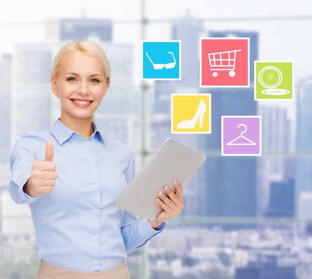 business, people and technology concept - smiling businesswoman or student with tablet pc computer shopping online and showing thumbs up in office