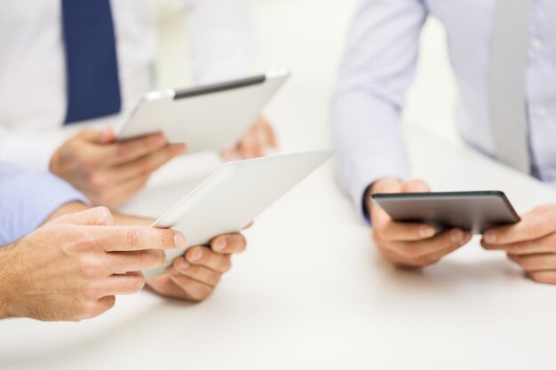 business, people, technology and teamwork concept - close up of businessman hands with tablet pc computer