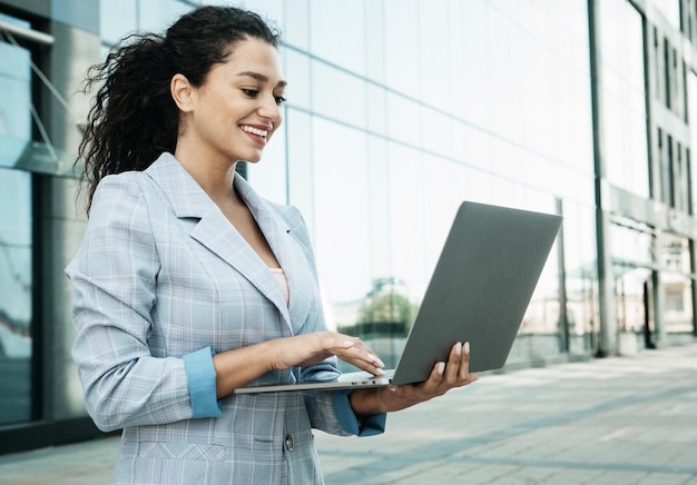 Business people tehnology and lifestyle concept portrait of a young African American woman work with laptop outdoors