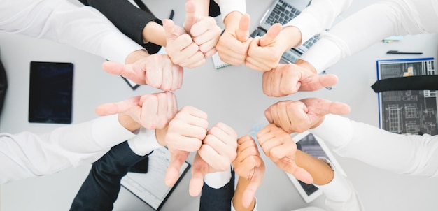 The business people thumb up on the desktop background view from above