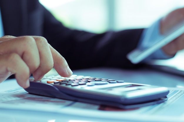 Business people use calculators to calculate their sales