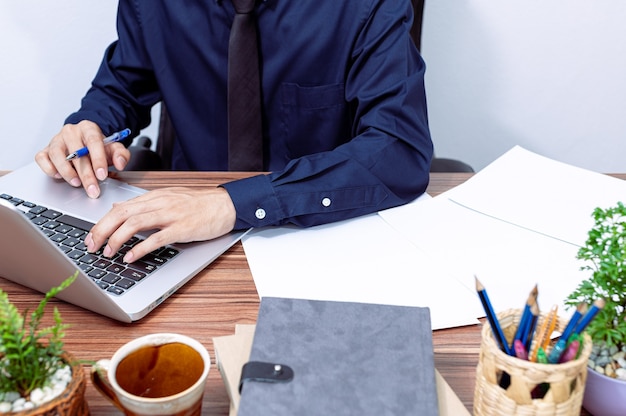 Business people use computers to work at their desks