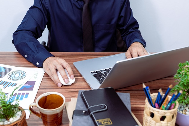 Business people use computers to work at their desks