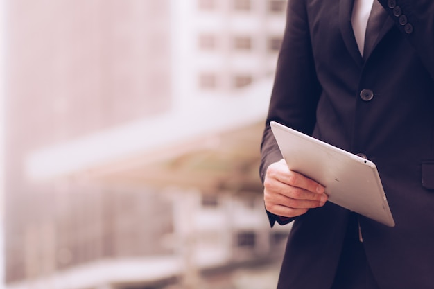 Business people use the tablet to work.