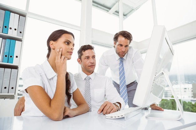 Business people using computer in office