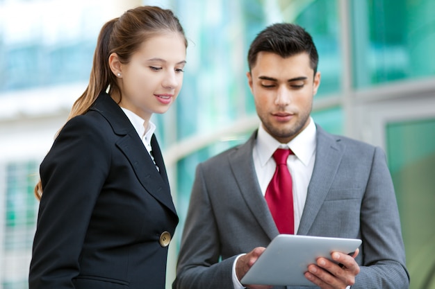 Business people using a digital tablet