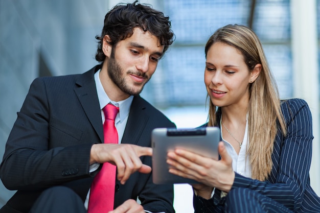 Business people using a digital tablet