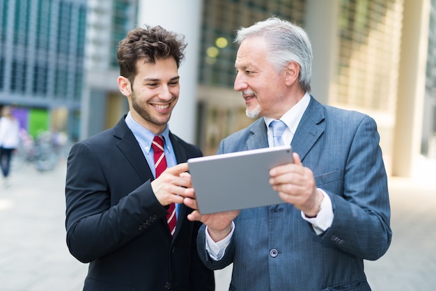 Business people using a tablet together