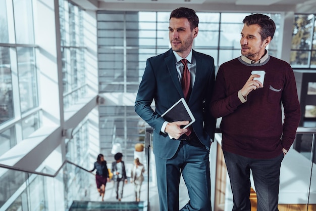 Business people using technology during their office break