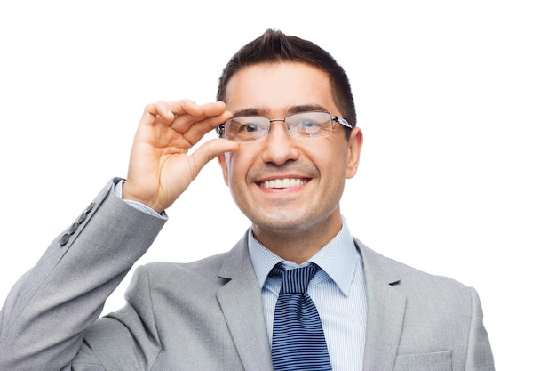 business, people, vision and office concept - happy smiling businessman in eyeglasses and suit