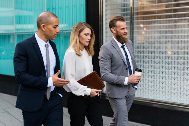 Business people walking around the city together and talking