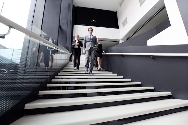 Business people walking down the steps of stairs