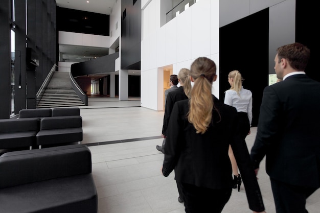 Business people walking in the lobby of modern building