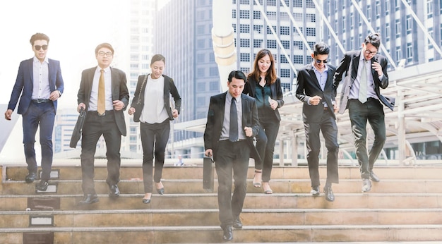 business people walking on steps in city