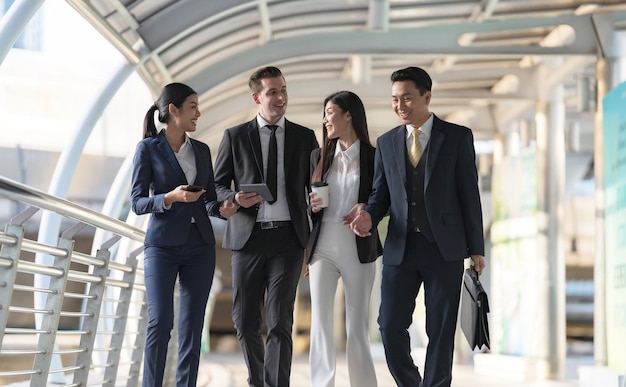 Business people walking and talk to each other in front of modern office