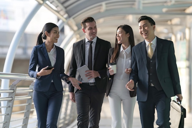 Business people walking and talk to each other in front of modern office