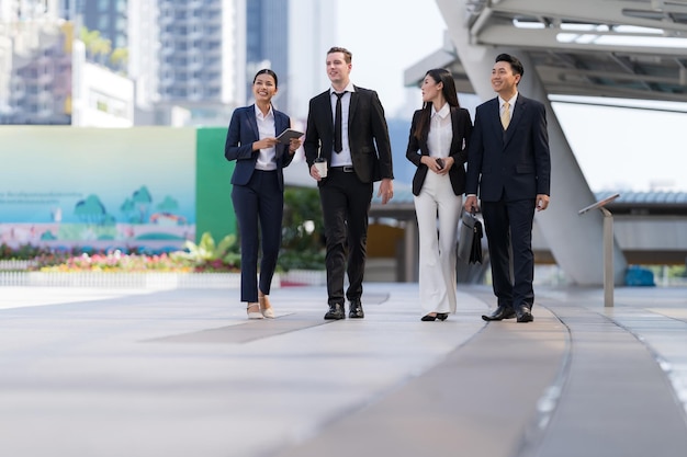 Business people walking and talk to each other in front of modern office