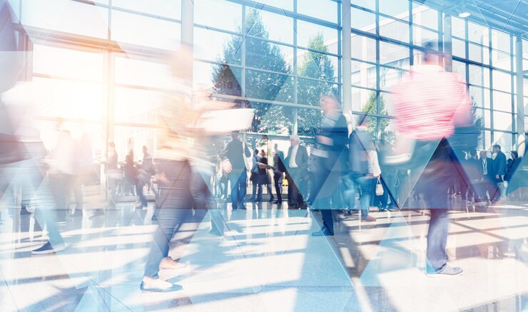 現代の会社のオフィスで歩いたり話したりするビジネスマン。幾何学模様と高層ビルの前景。トーン画像の二重露光のモックアップがぼやけています