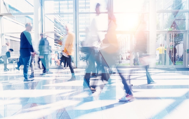 Business people walking and talking in a modern company office. Geometric pattern and skyscrapers foreground. Toned image double exposure mock up blurred