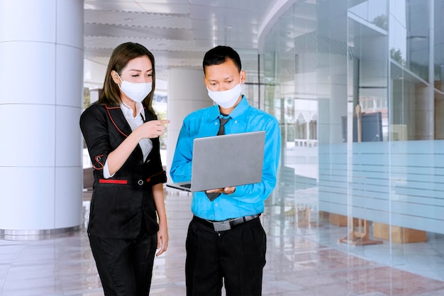 Business people wear mask while discuss in office