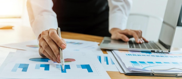 Business people in white shirt working and calculating about finance with document report and laptop computer on desk at home office digital online marketing and financial business concept