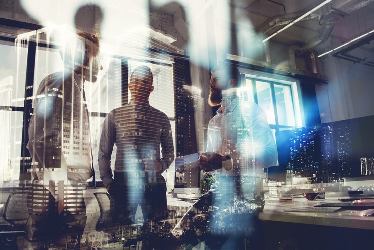 Photo business people work together in office concept of teamwork and partnership double exposure with modern city and light effects