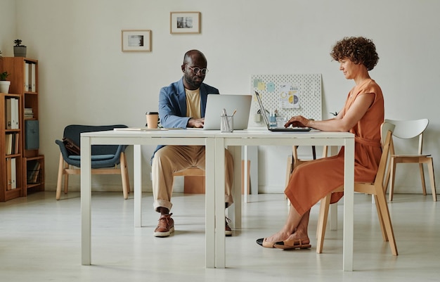 Business people working on computers at office