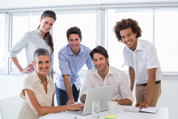 Business people working on laptop smile to camera