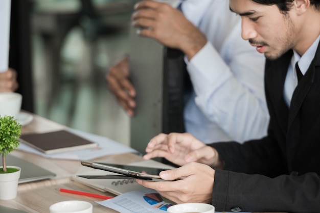 Business people working at the meeting desk together in teamwork.