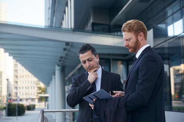 Business people working outside office building