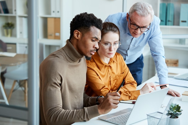 Business people working in team on laptop