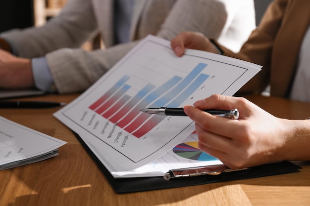 Business people working with charts and graphs at table in office closeup Investment analysis