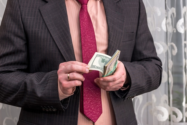 Business person counting dollar banknotes in hands