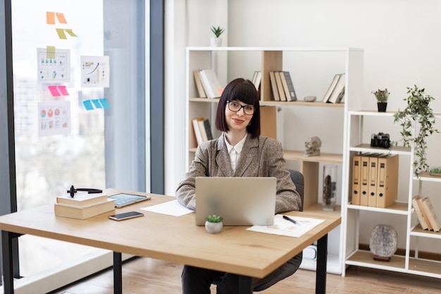 Business person thinking over project details while looking into display of pc